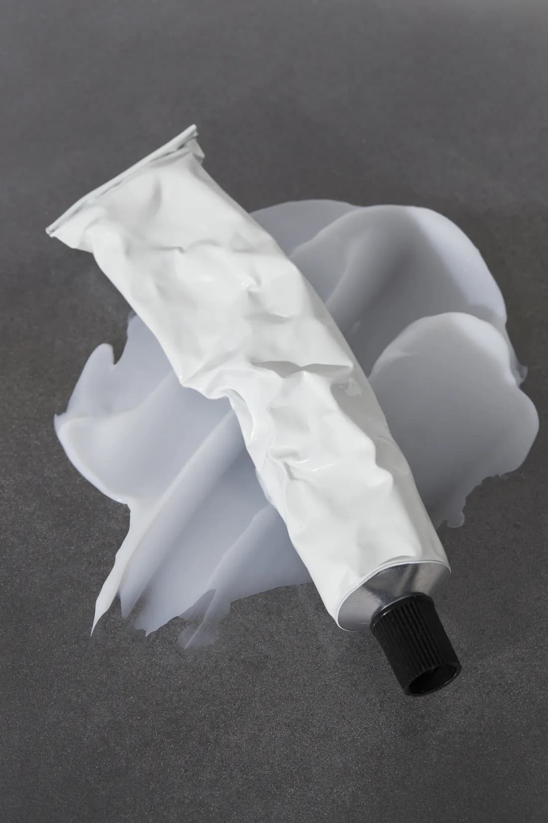 An unlabelled aluminium tube and white paste