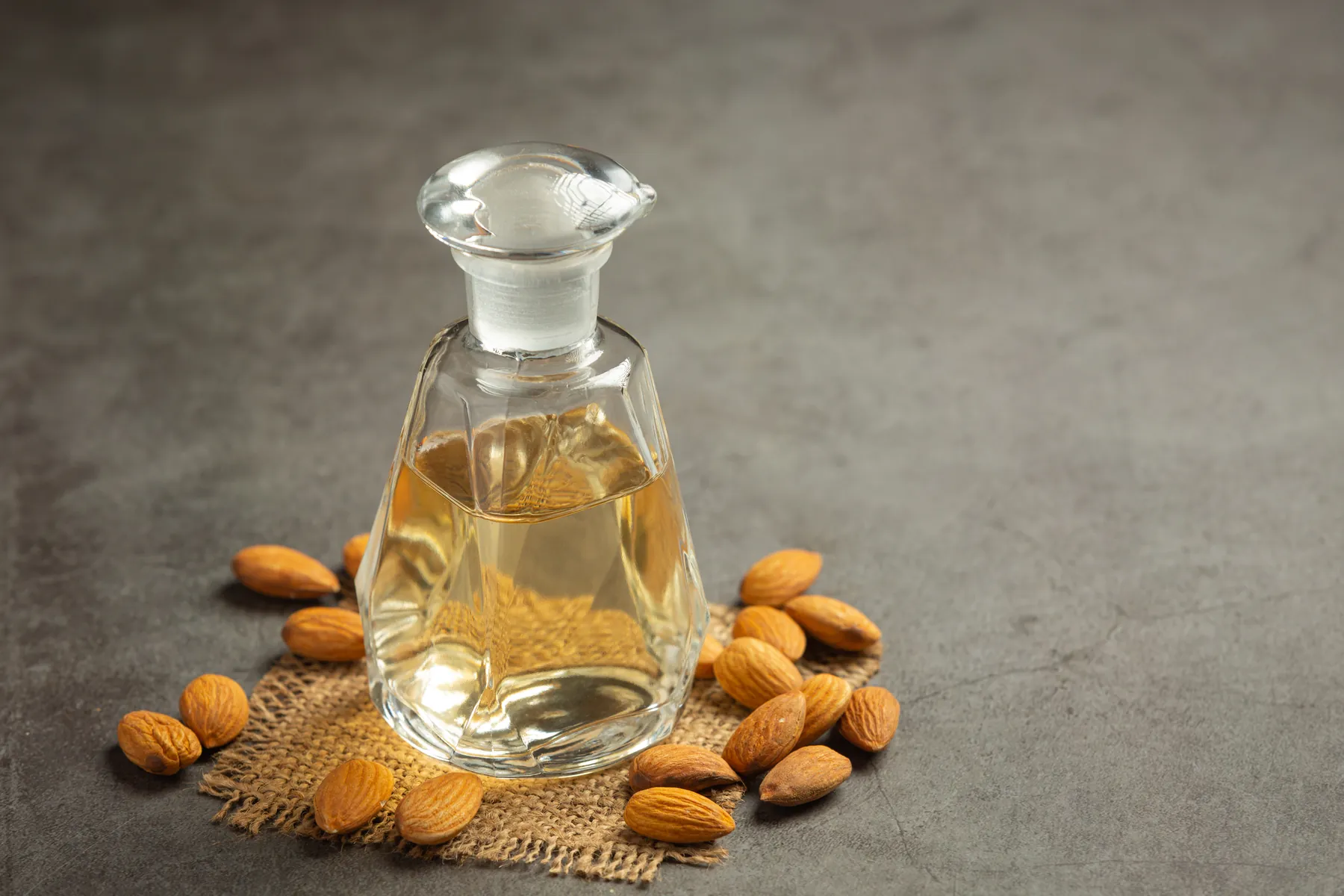Botanical oil in a glass bottle on a dark surface