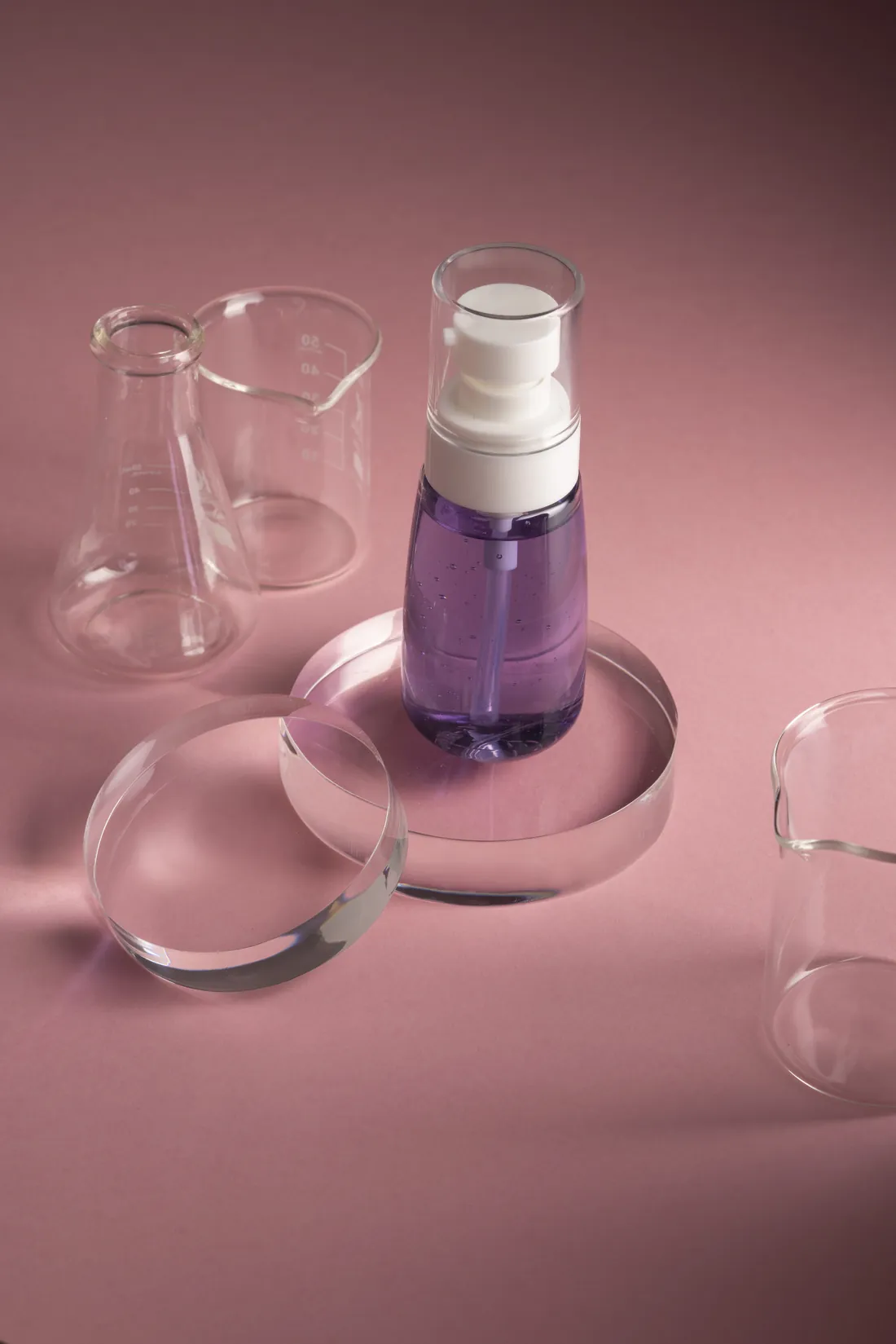 A serum bottle beside laboratory glassware